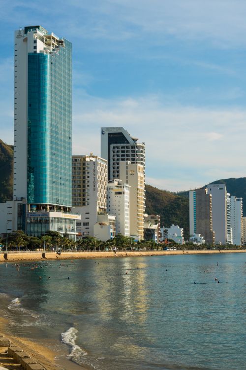 Free Stunning view of modern skyscrapers towering over a serene waterfront, perfect for urban travel themes. Stock Photo