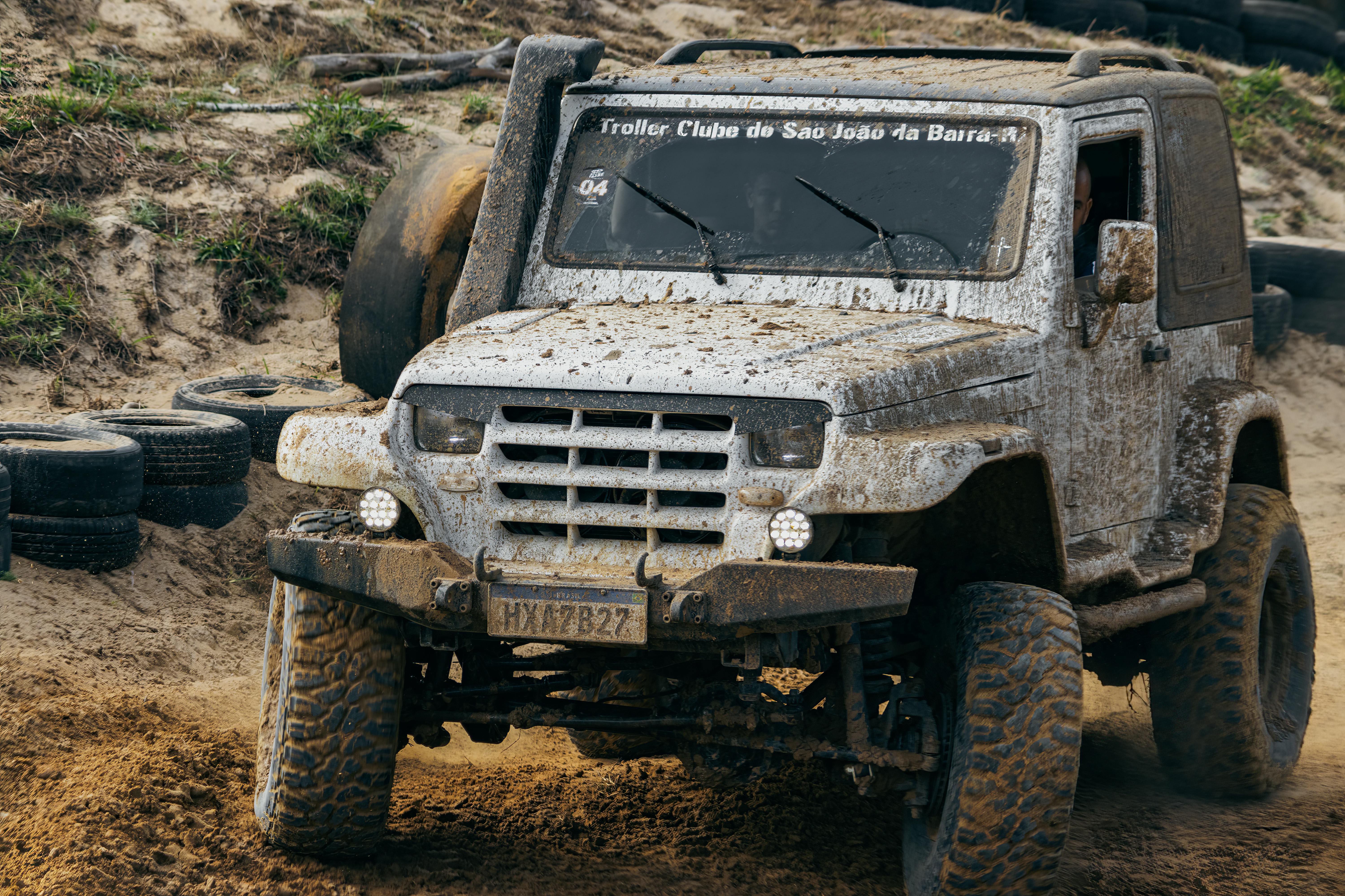 Muddy 4x4 truck navigating an off-road terrain showcasing adventurous spirit.