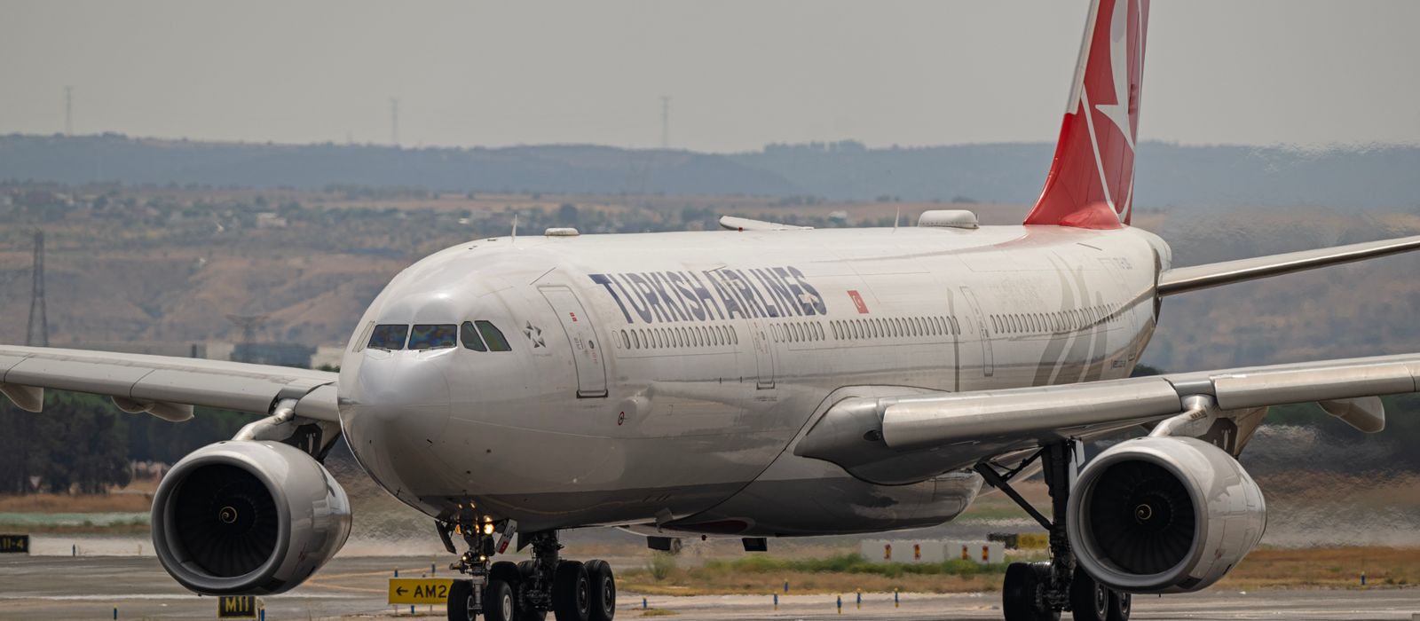 Turkish Airlines Airbus jet prepares for takeoff at Madrid airport.