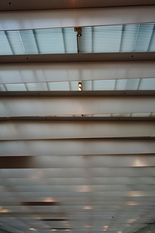 Free Contemporary interior ceiling featuring glass panels and structural steel elements. Stock Photo
