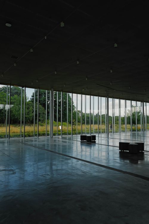 Free Spacious modern interior with glass walls offering a serene view of nature outdoors. Stock Photo