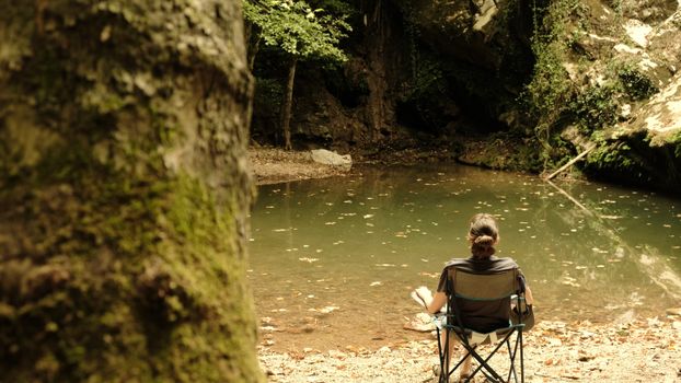 A person enjoying solitude by a serene lake in Hacıllı, İstanbul, Türkiye.