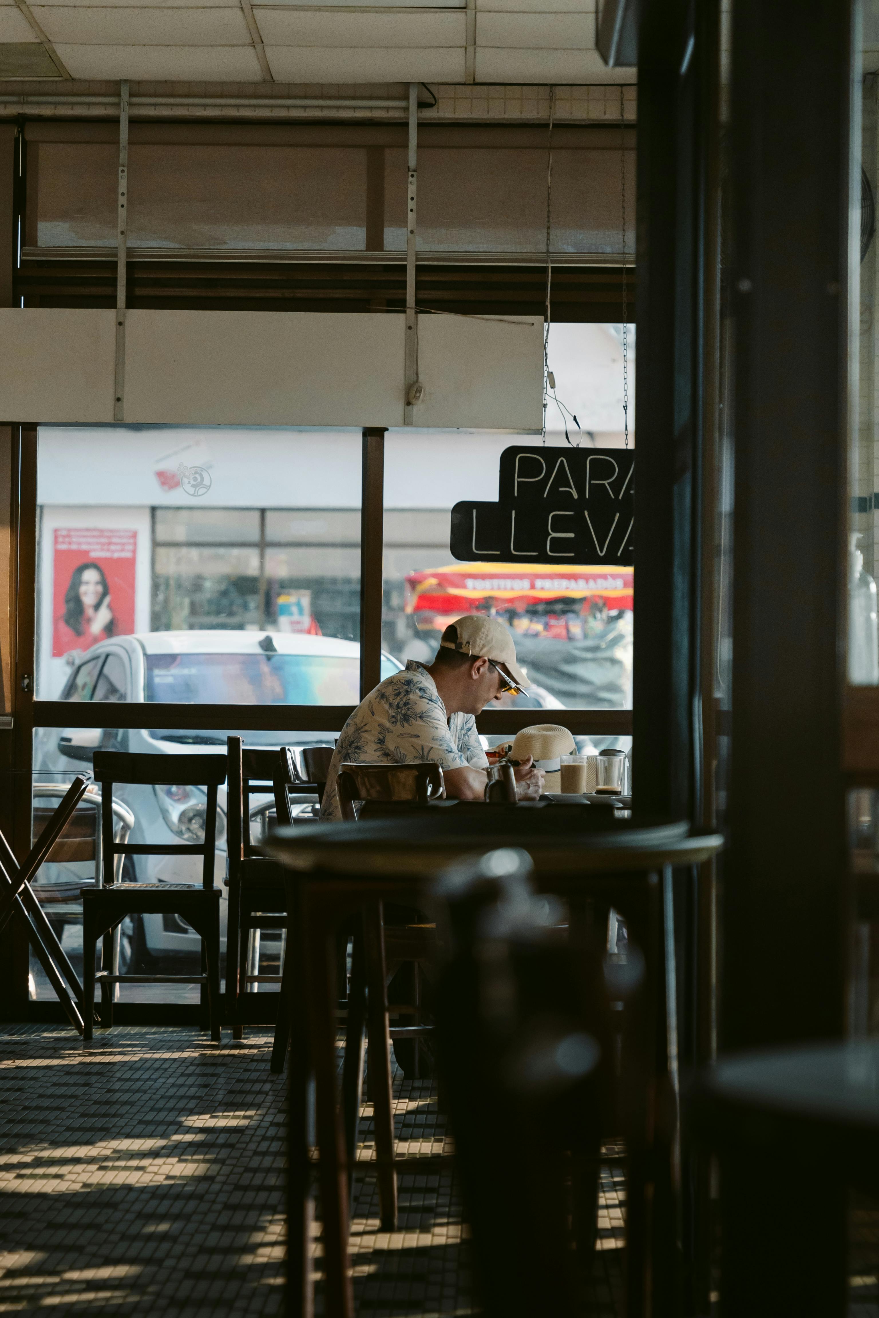 a woman sitting at a table in a cafe