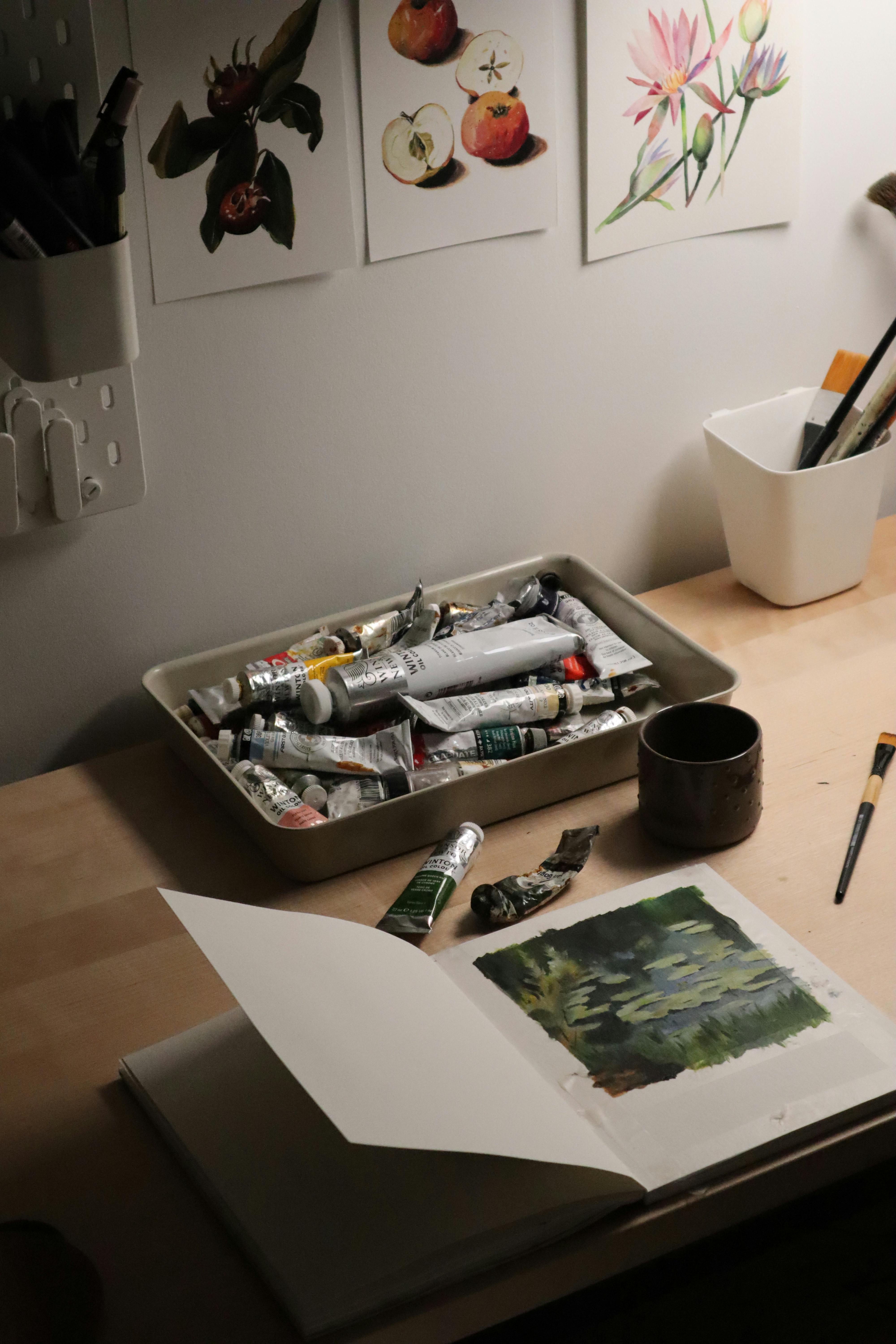 A quiet indoor art studio with painting supplies and artwork, optimal for creativity.