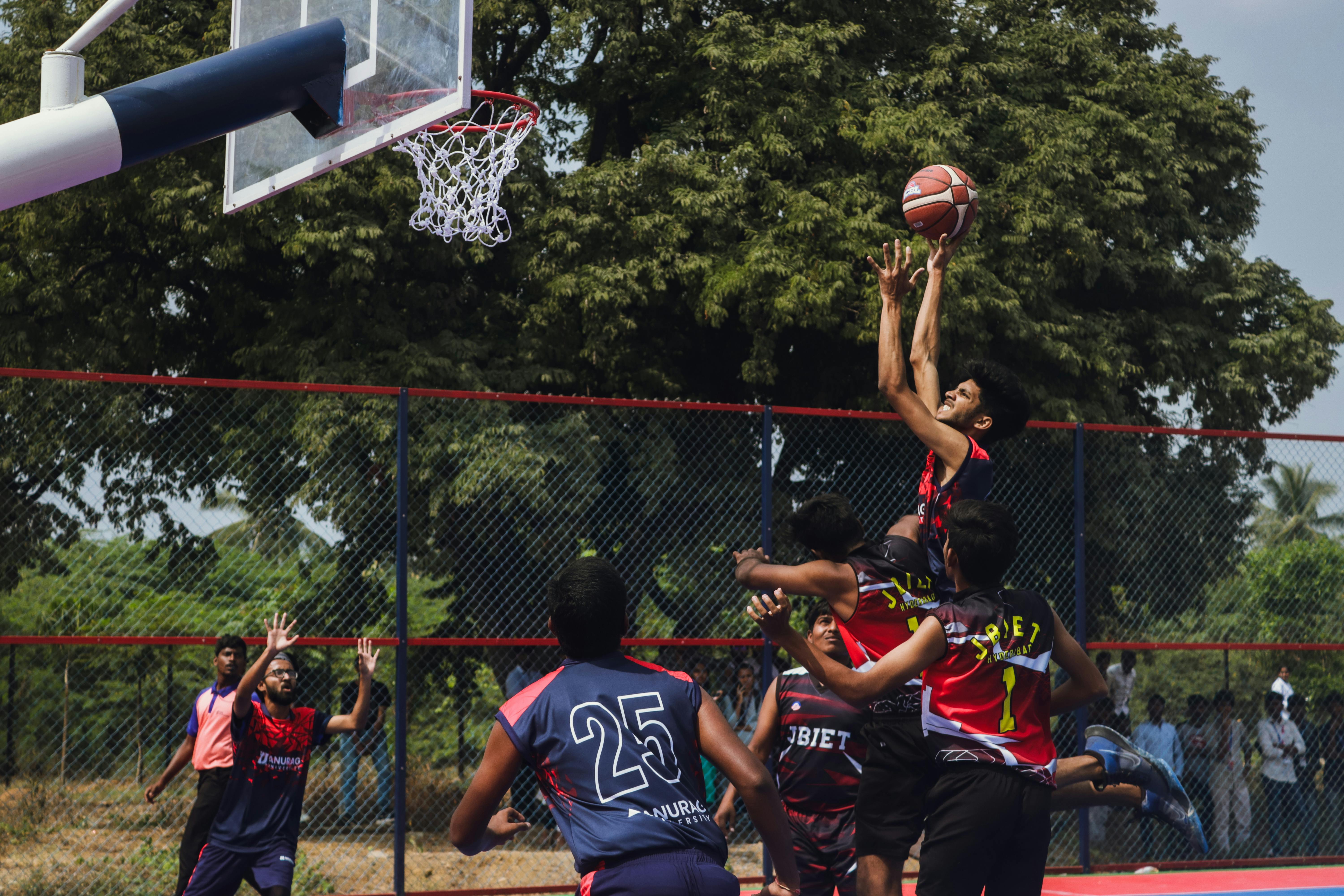 a group of people playing basketball on a court