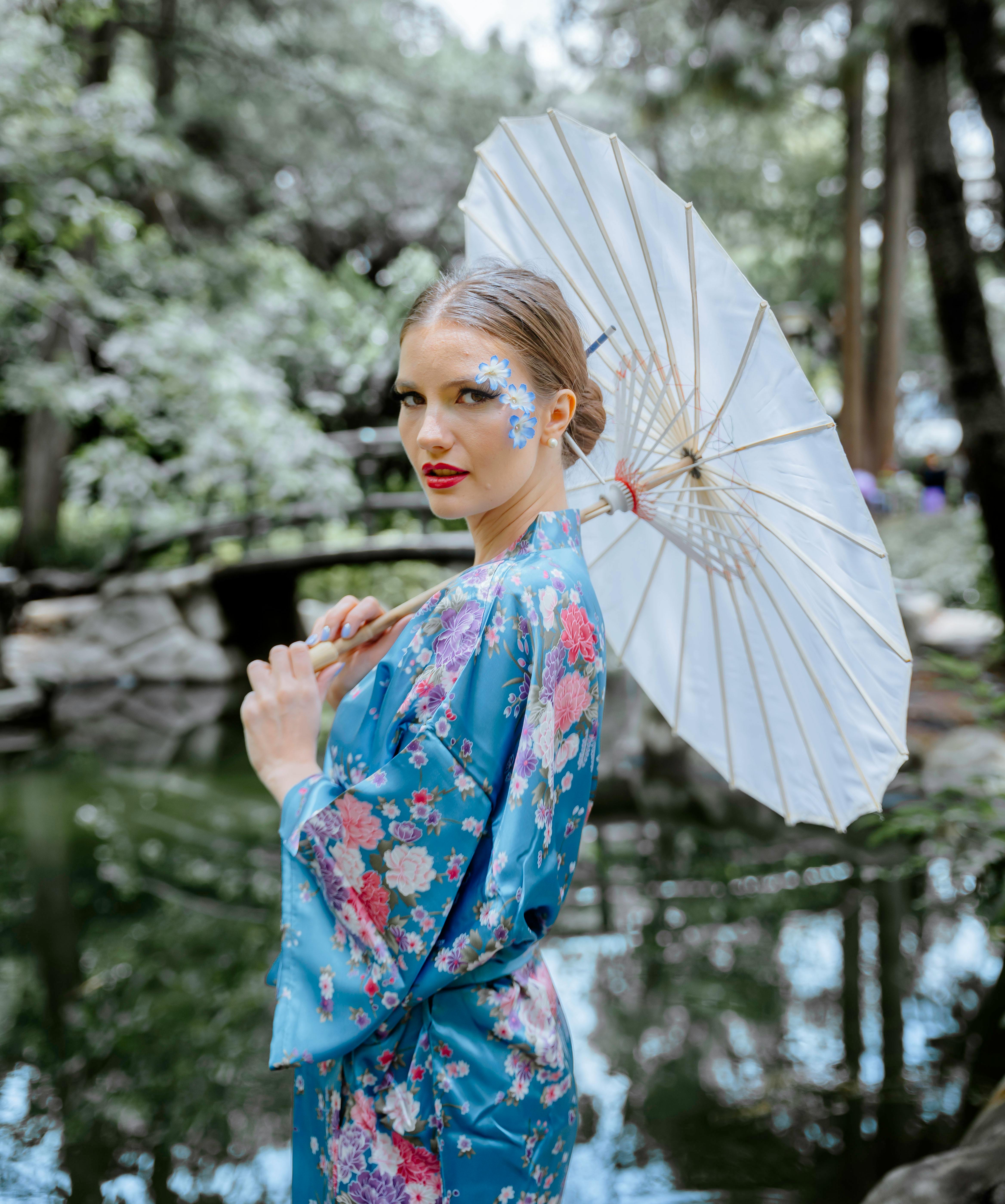 a woman in a kimono holding an umbrella