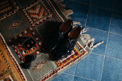 Pair of Black Leather Dress Shoes on Rug