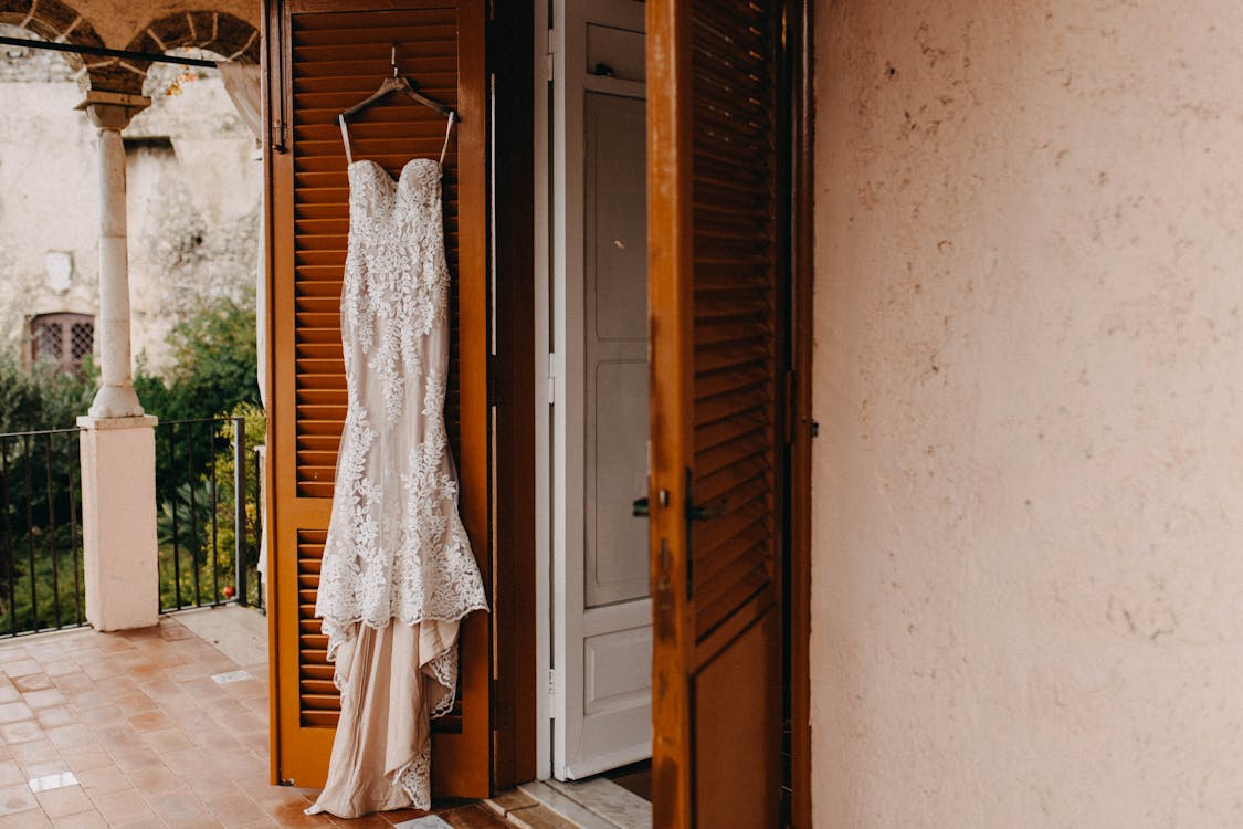 White Wedding Dress Hanging On The Door