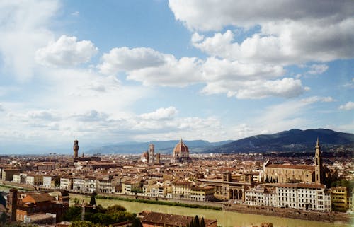 City Buildings Under Blue Sky and White Clouds