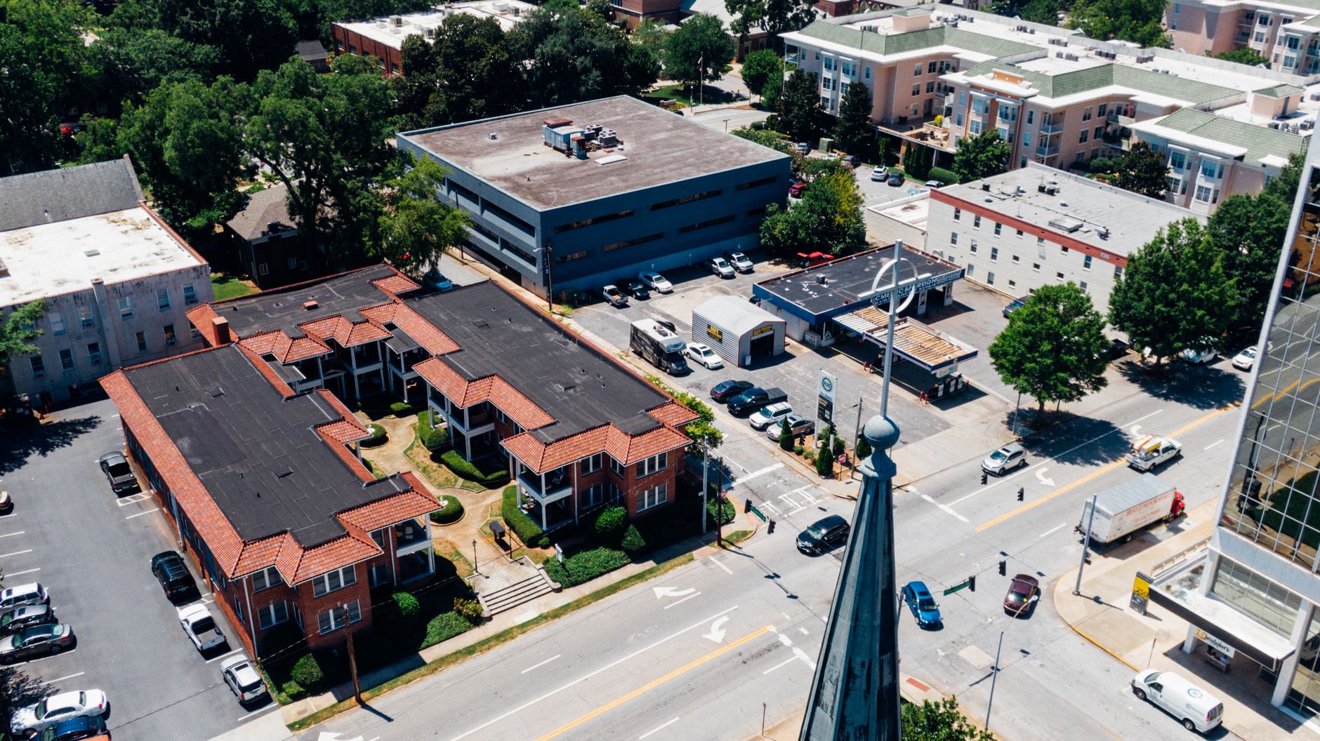 Aerial view of Decatur cityscape showing streets, buildings, and vehicles on a sunny day.