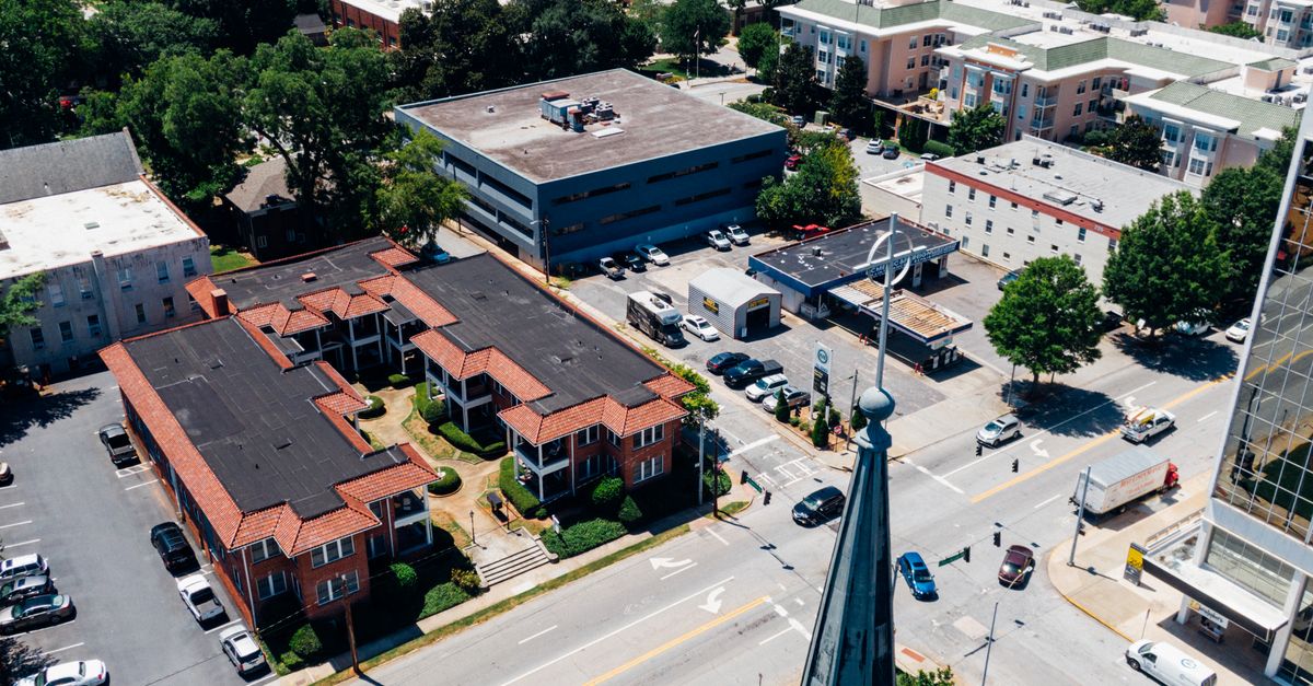 Aerial view of Decatur cityscape showing streets, buildings, and vehicles on a sunny day.
