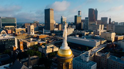 Free A stunning aerial view of the Atlanta skyline with iconic landmarks and urban landscape under a blue sky. Stock Photo