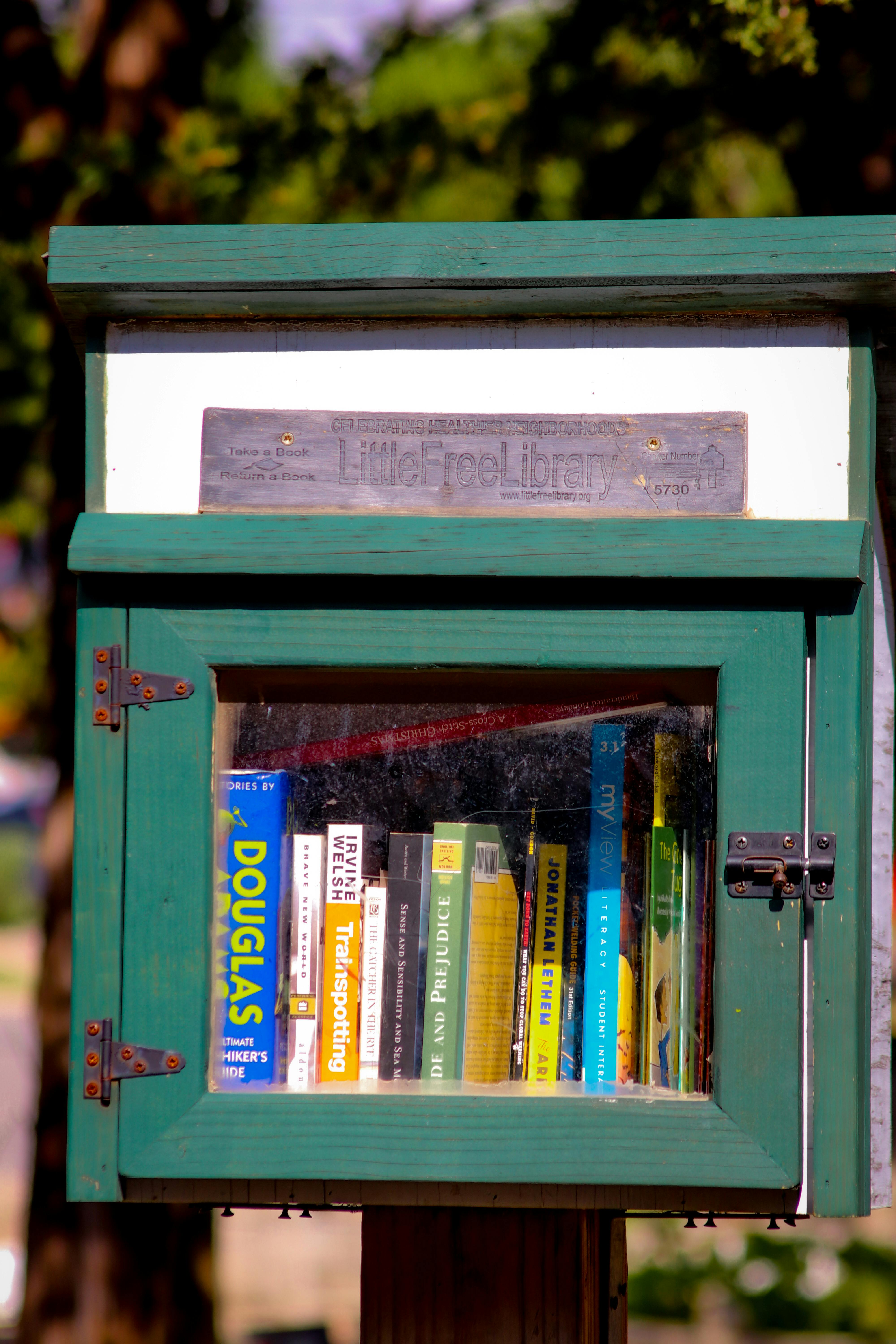 a green book box with books inside