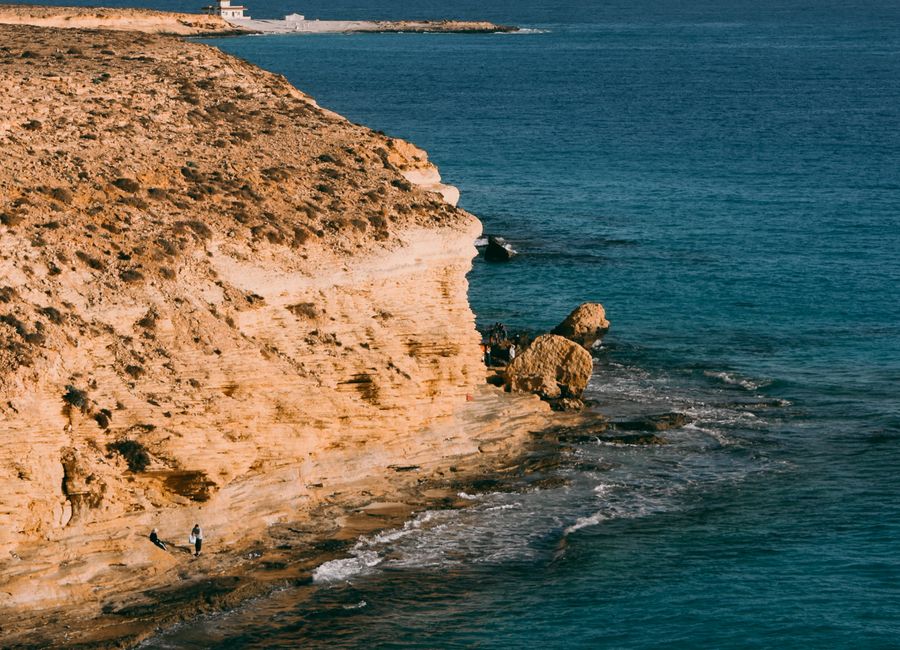 Explore the stunning coastal cliffs and clear blue waters of Marsa Matruh, Egypt.
