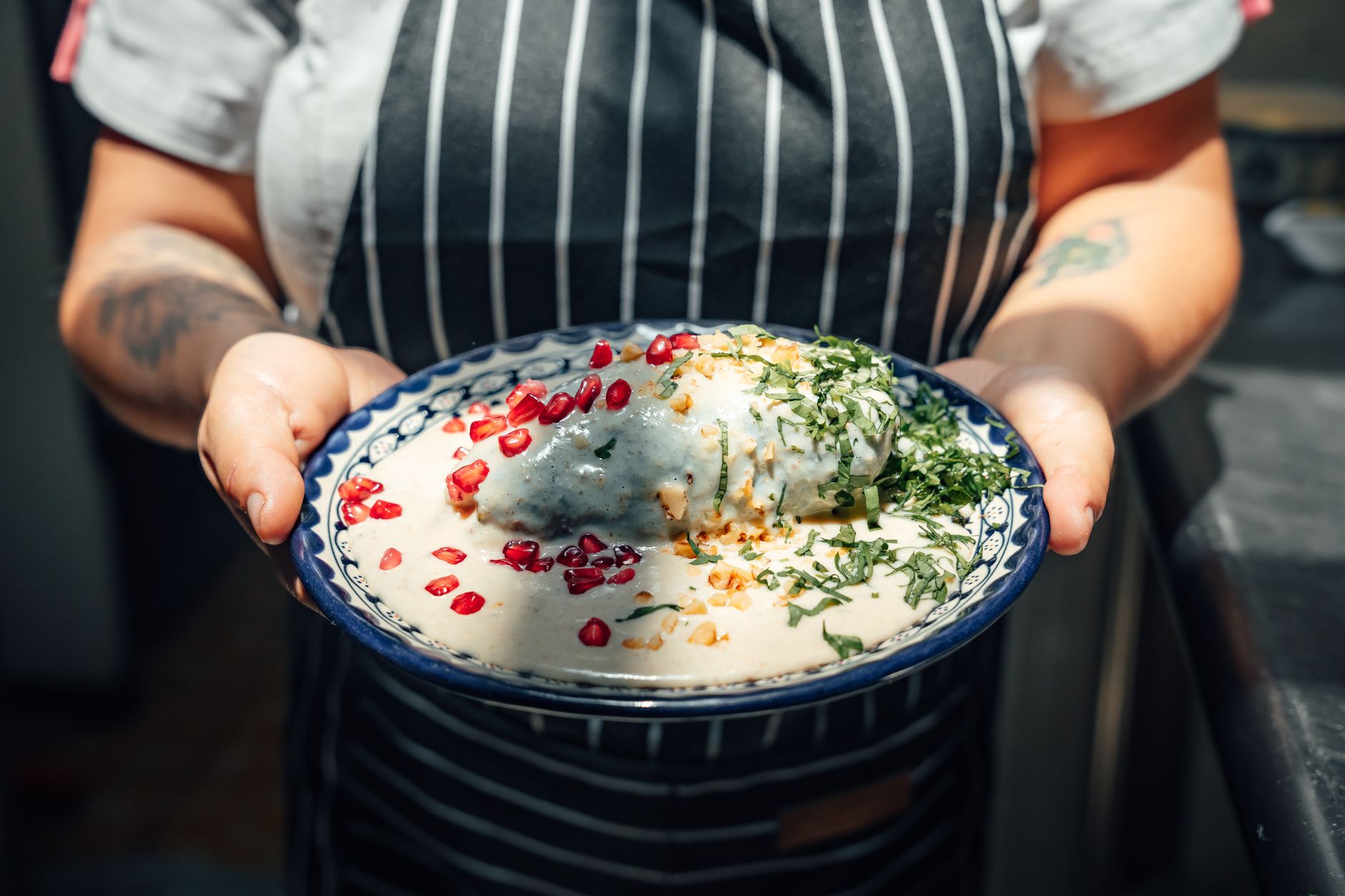 Green Chile Sauce in a bowl with fresh limes