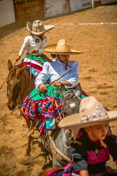Vibrant Mexican charro festival showcasing traditional attire and horsemanship in Pachuca de Soto.