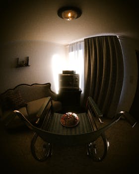 A warmly lit vintage living room with a retro TV, couch, and curtains.