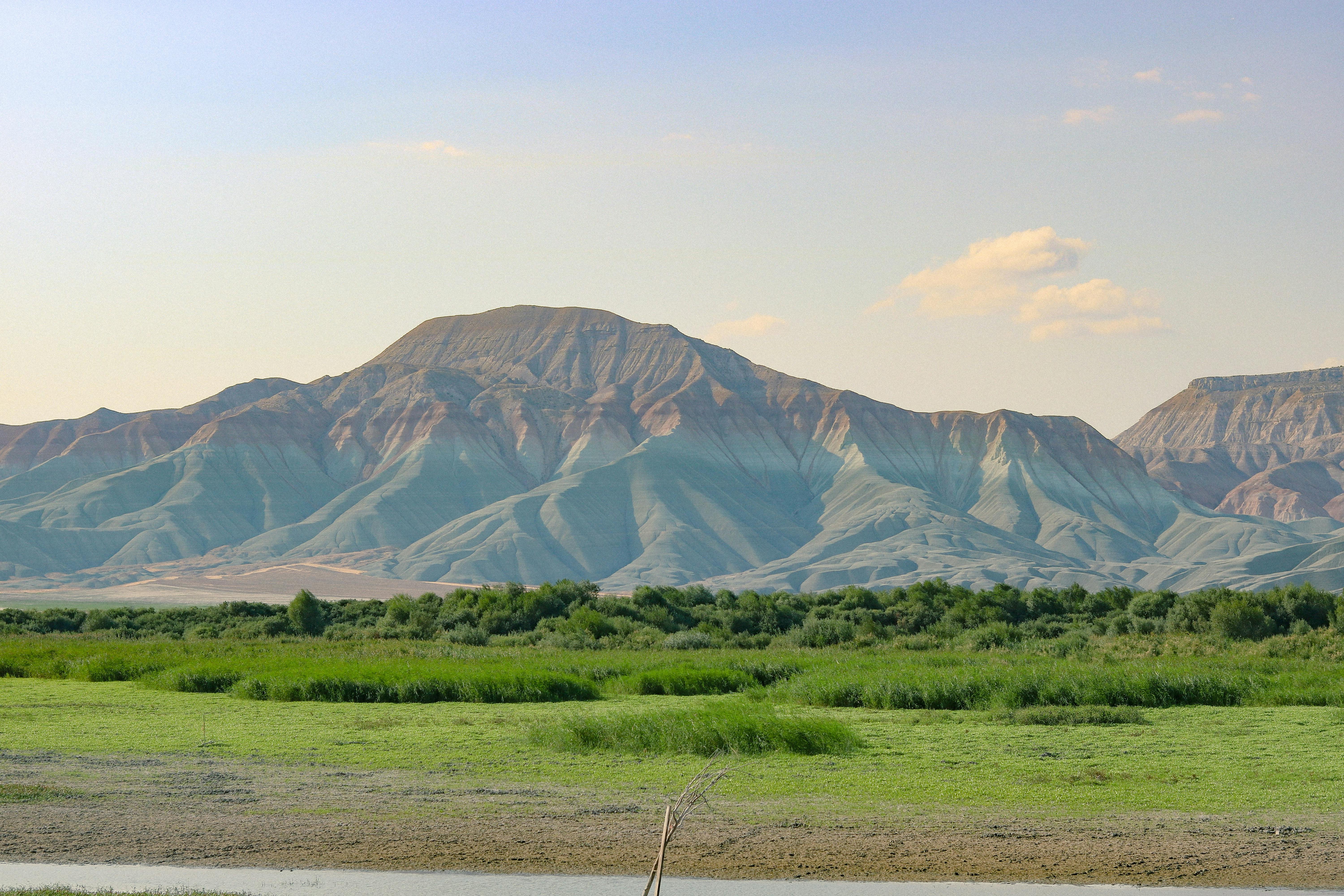 a large body of water with mountains in the background