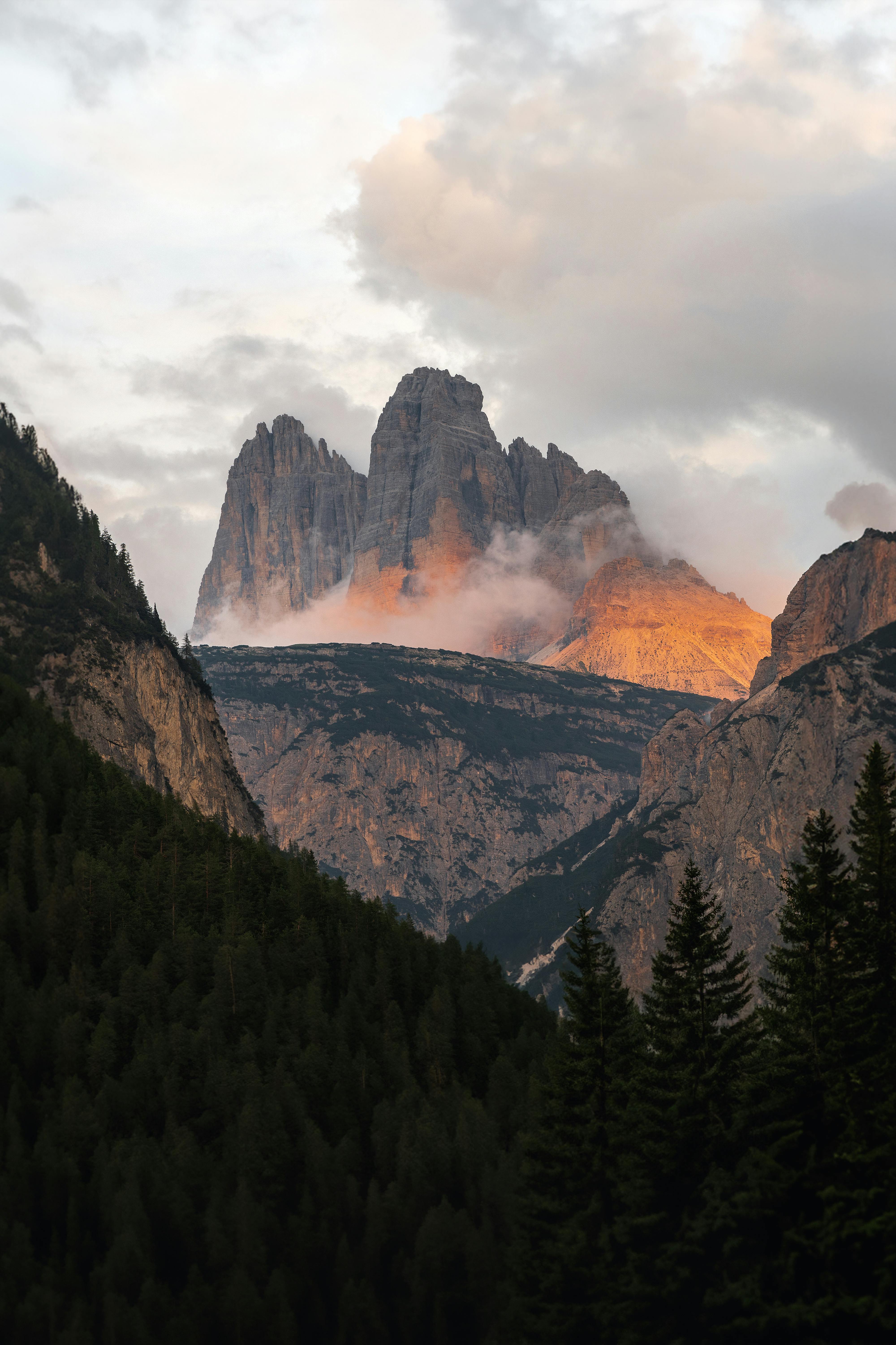 A stunning view of misty mountains during sunset, showing dramatic skies.