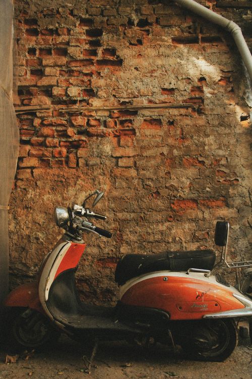Free A classic scooter parked by a weathered brick wall, capturing Istanbul's vintage urban charm. Stock Photo