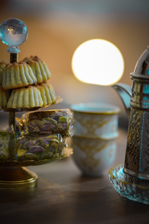 Free Close-up of Arabic coffee and sweets on a table in a warm indoor setting. Stock Photo