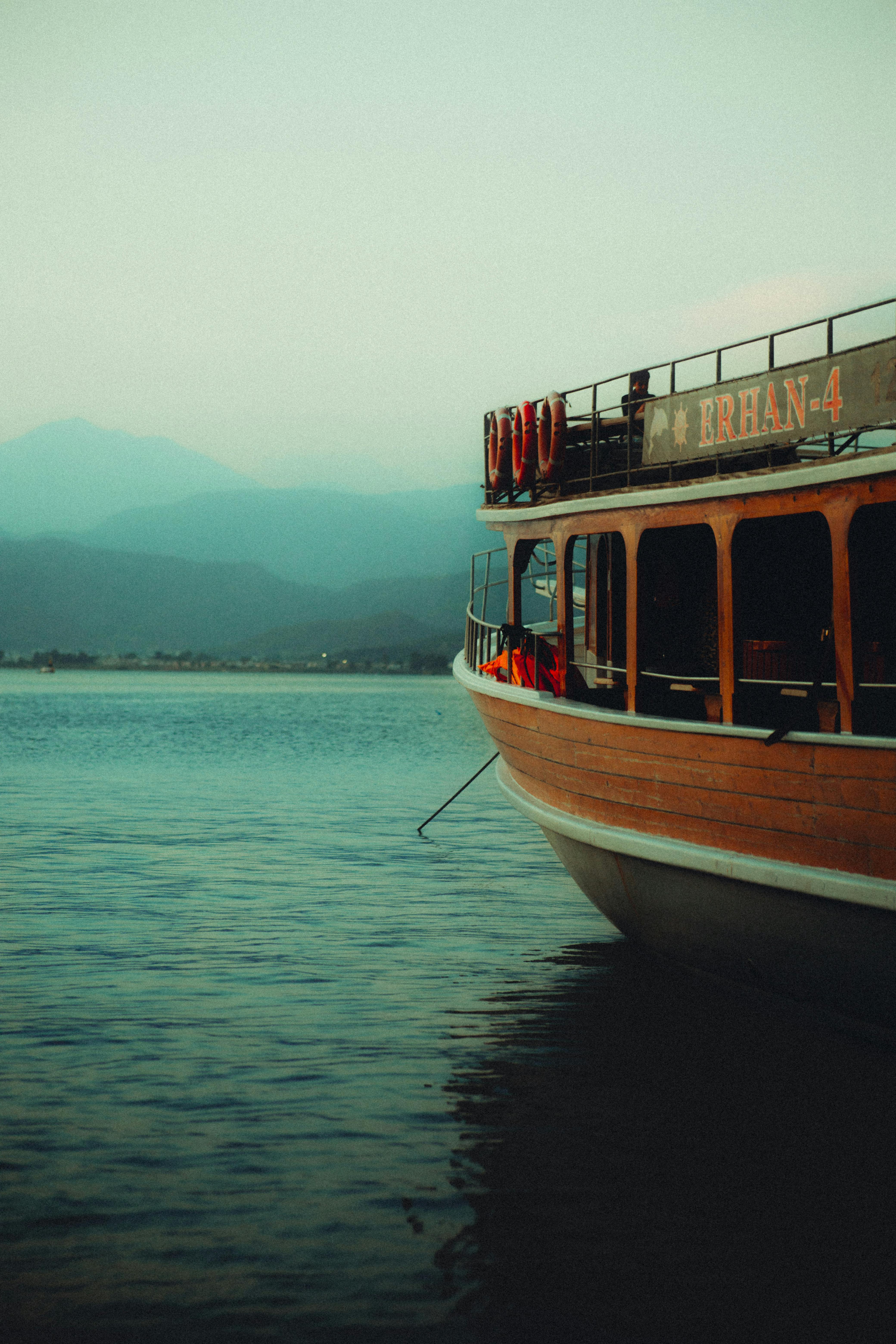 a boat is sitting in the water near mountains