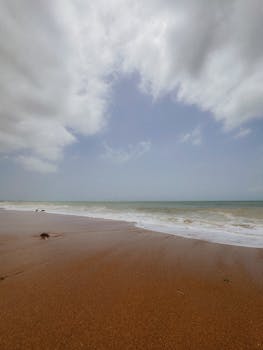 Peaceful seascape with waves and cloudy sky at Karachi beach.