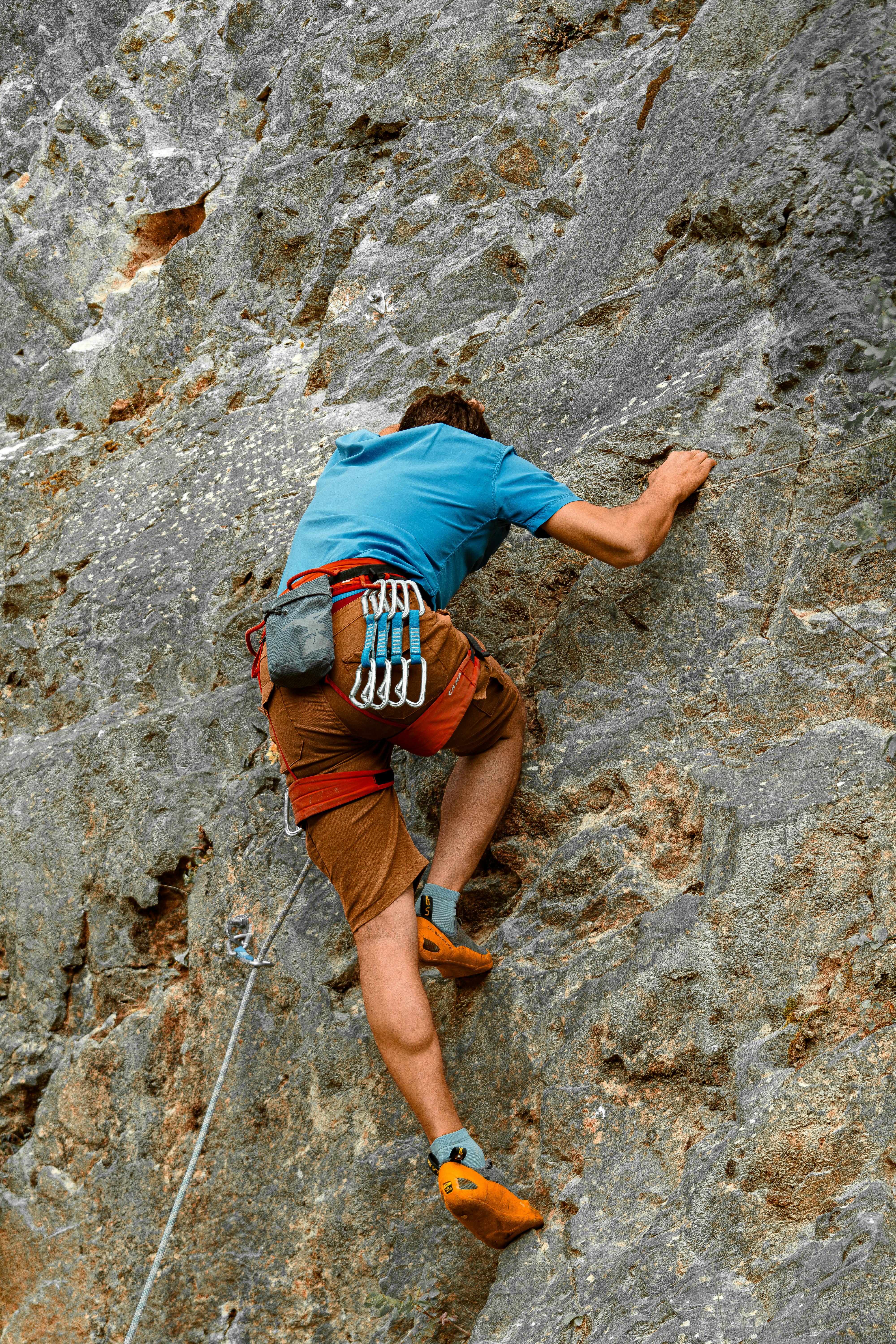 Adventurous man rock climbing on a rugged cliff in Yalova, Türkiye.