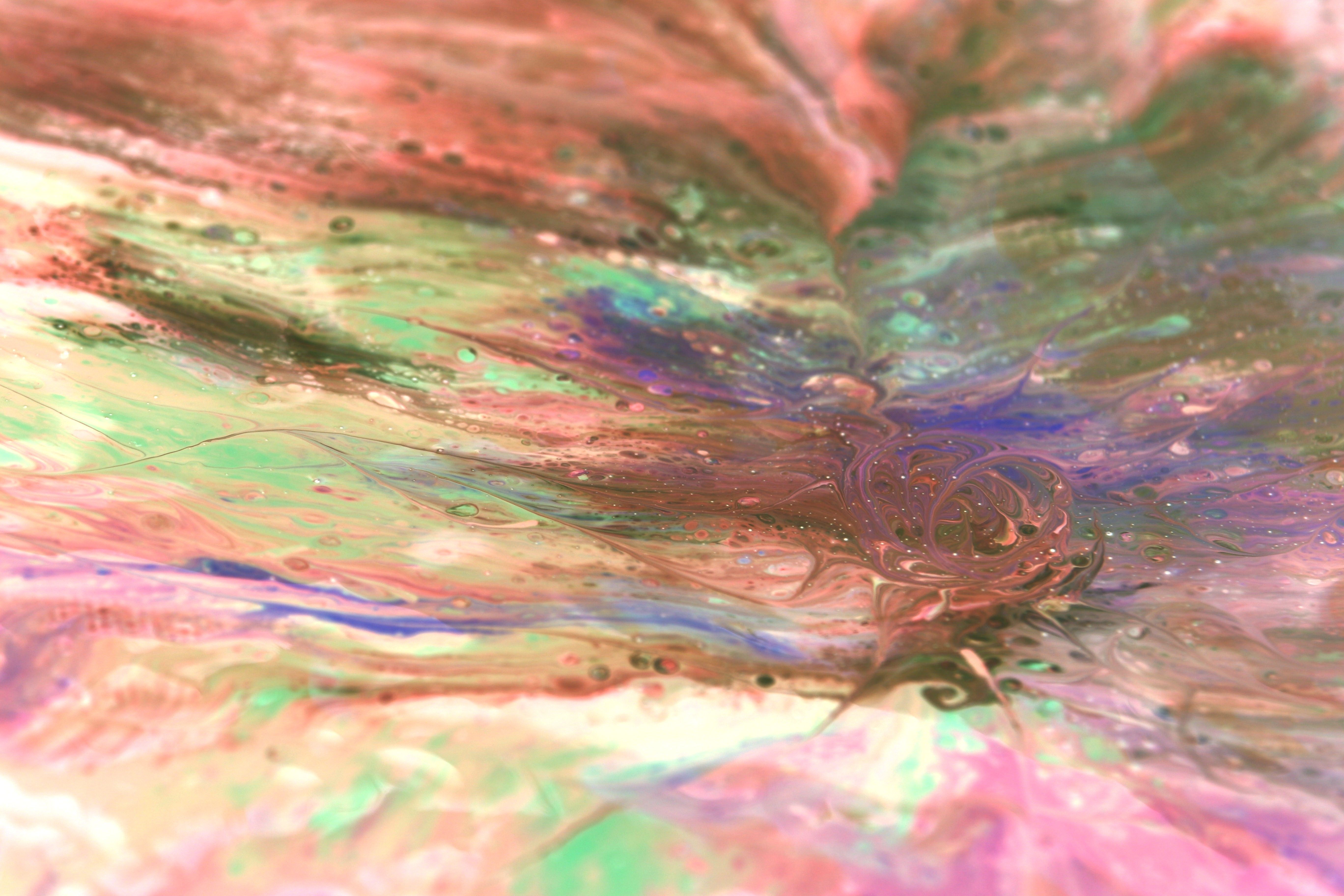 Vibrant abstract fluid art with swirling pastel colors, showcasing a dynamic blend of textures and patterns.
