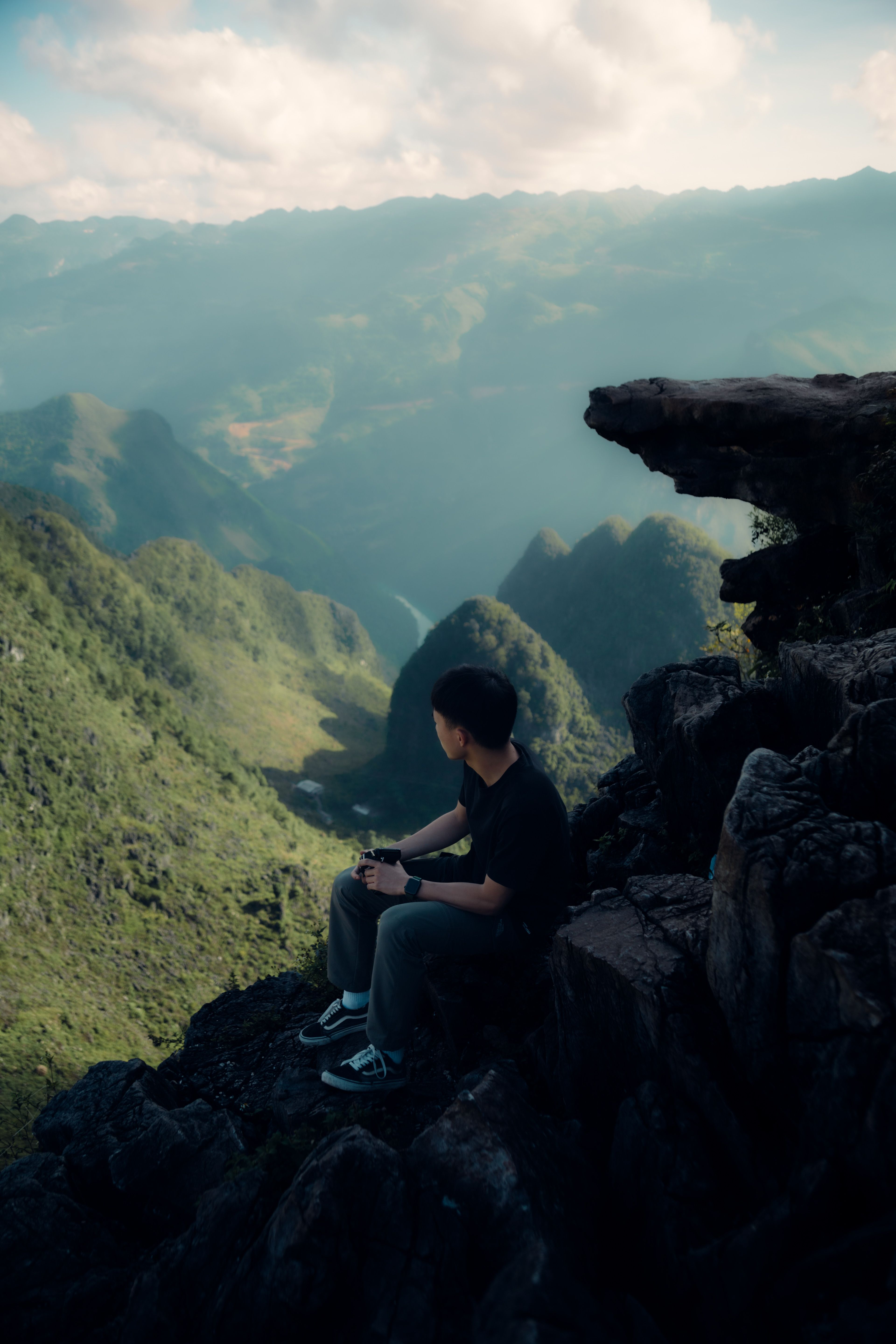 A person sitting on top of a mountain · Free Stock Photo