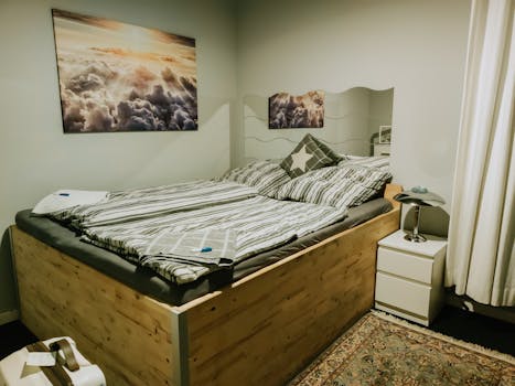 Modern bedroom interior featuring a wooden bed, stylish decor, and warm lighting for a cozy atmosphere.