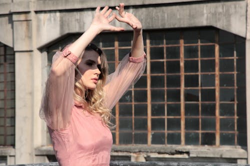 Woman Wearing Pink 3/4-sleeved Top Covering Sunlight On Her Face