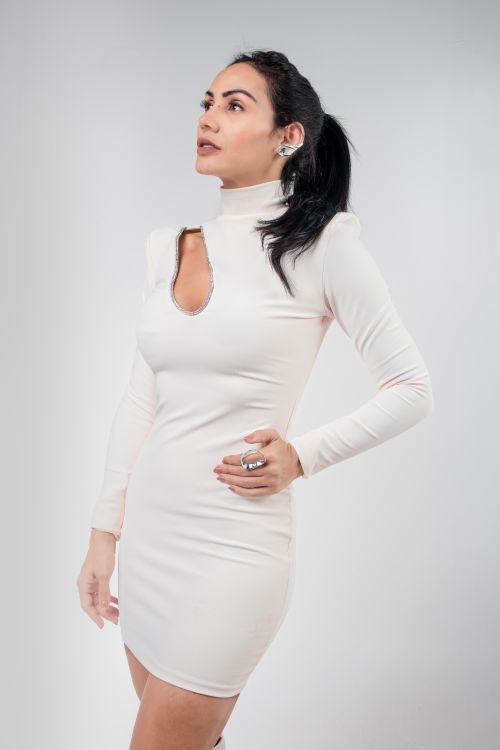 Free A stylish woman in a white dress poses confidently against a neutral background. Stock Photo