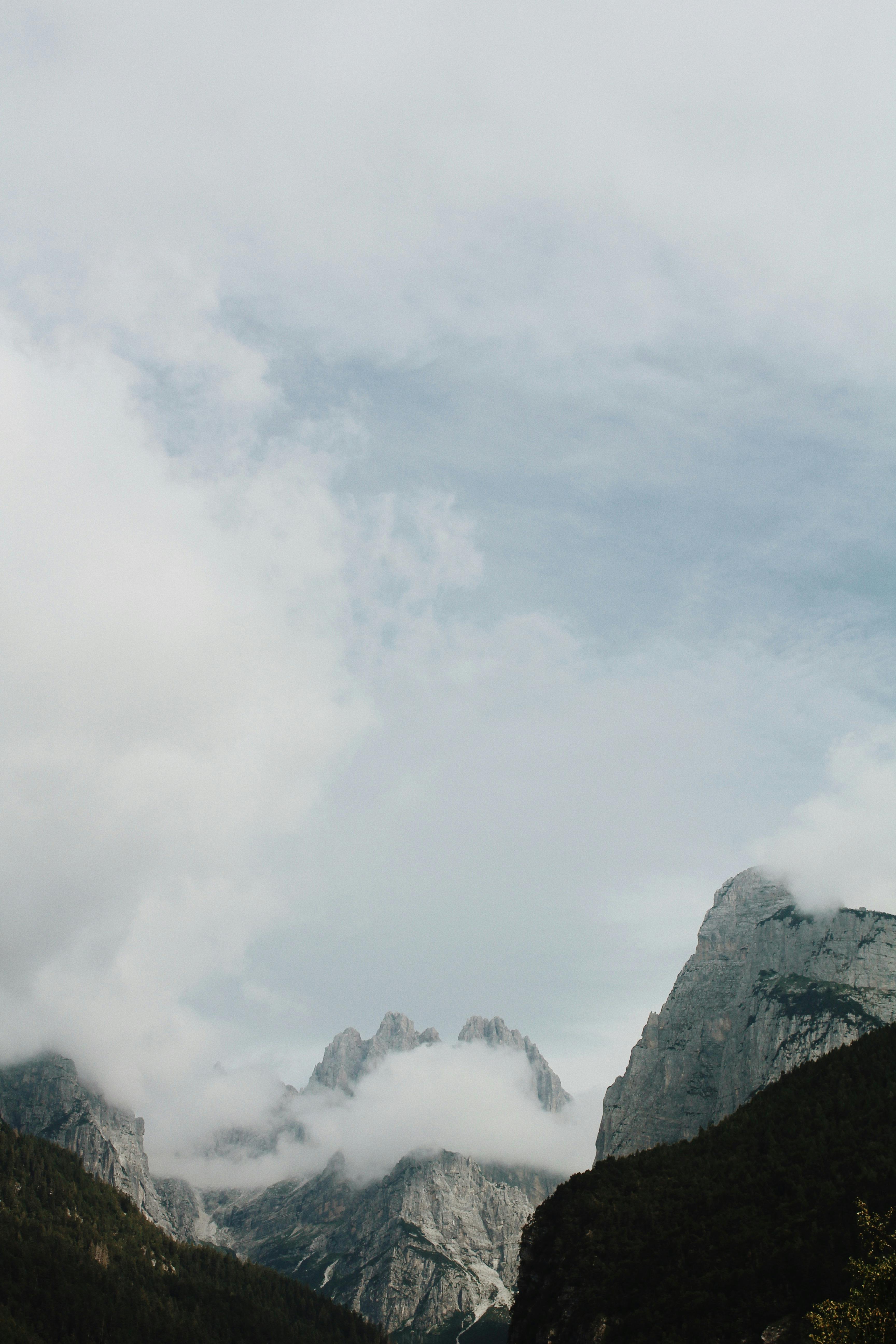 Scenic view of foggy mountains in Molveno, blending nature and tranquility.