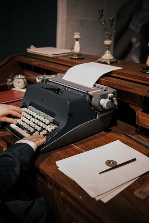 Free Old-fashioned typewriter on desk with papers, ideal for vintage business concepts. Stock Photo