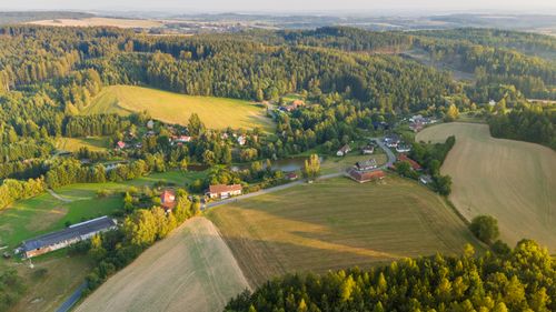 Free Scenic aerial view of rolling hills, forest, and village in Petrovice II, capturing Central Bohemian landscape. Stock Photo