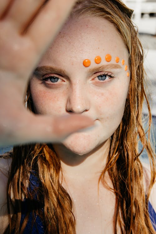 Woman Face With Orange Stickers