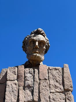 Stone bust of Abraham Lincoln against a clear blue sky in Laramie, Wyoming.