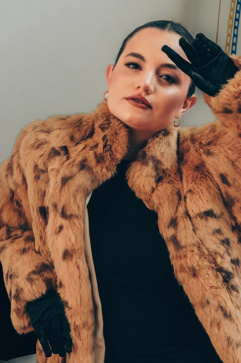 Woman in leopard print coat with black gloves