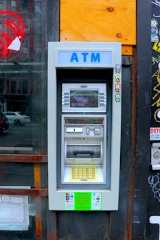 Street ATM machine in an urban setting, ideal for finance and commerce themes.