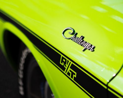 Free Close-up of a vibrant green Dodge Challenger RT emblem, showcasing retro design and dynamic style. Stock Photo