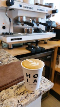A cappuccino with latte art in a cafe with coffee equipment in Zacatecas, Mexico.