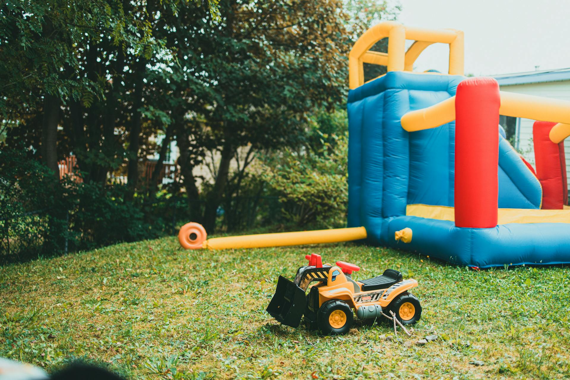 A toy tractor is sitting in front of a bouncer