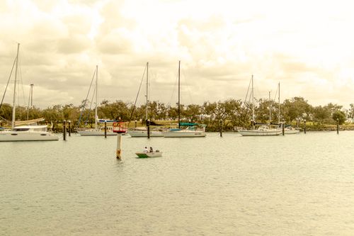 Free Yachts anchored at a serene marina on Sunshine Coast, Australia, under a cloudy sky. Stock Photo