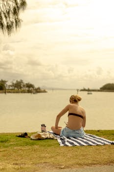 Woman enjoying a summer day by the water on Sunshine Coast, Australia.