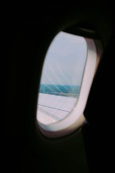 A tranquil view of the landscape through an airplane window.