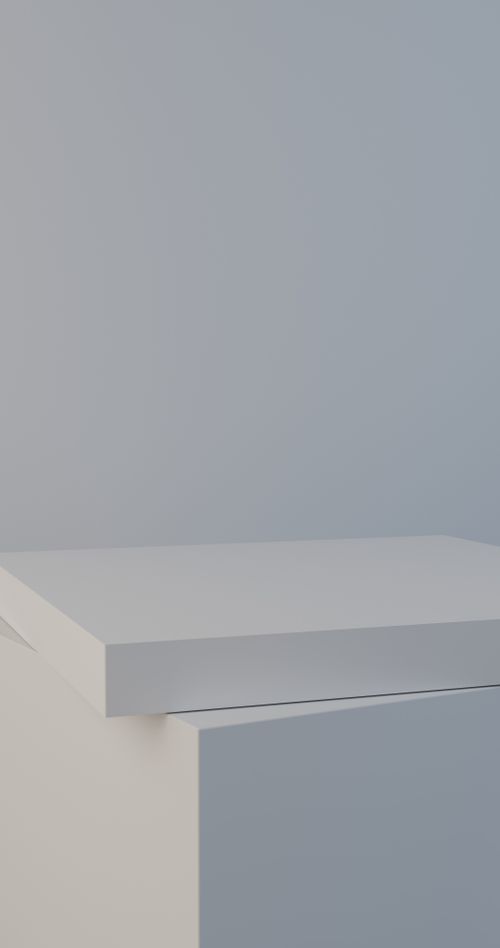 Free A simple minimalist white furniture piece against a light gray wall, showcasing modern design. Stock Photo