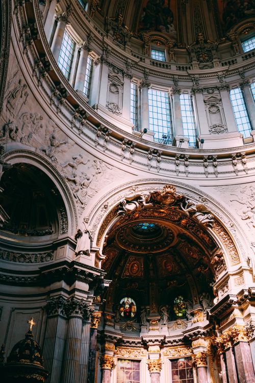 Free Captivating low-angle view of a stunning cathedral's dome with intricate art and stained glass. Stock Photo