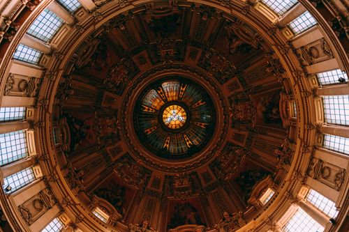 Free Intricate church dome interior with stunning stained glass and symmetrical design, viewed from below. Stock Photo