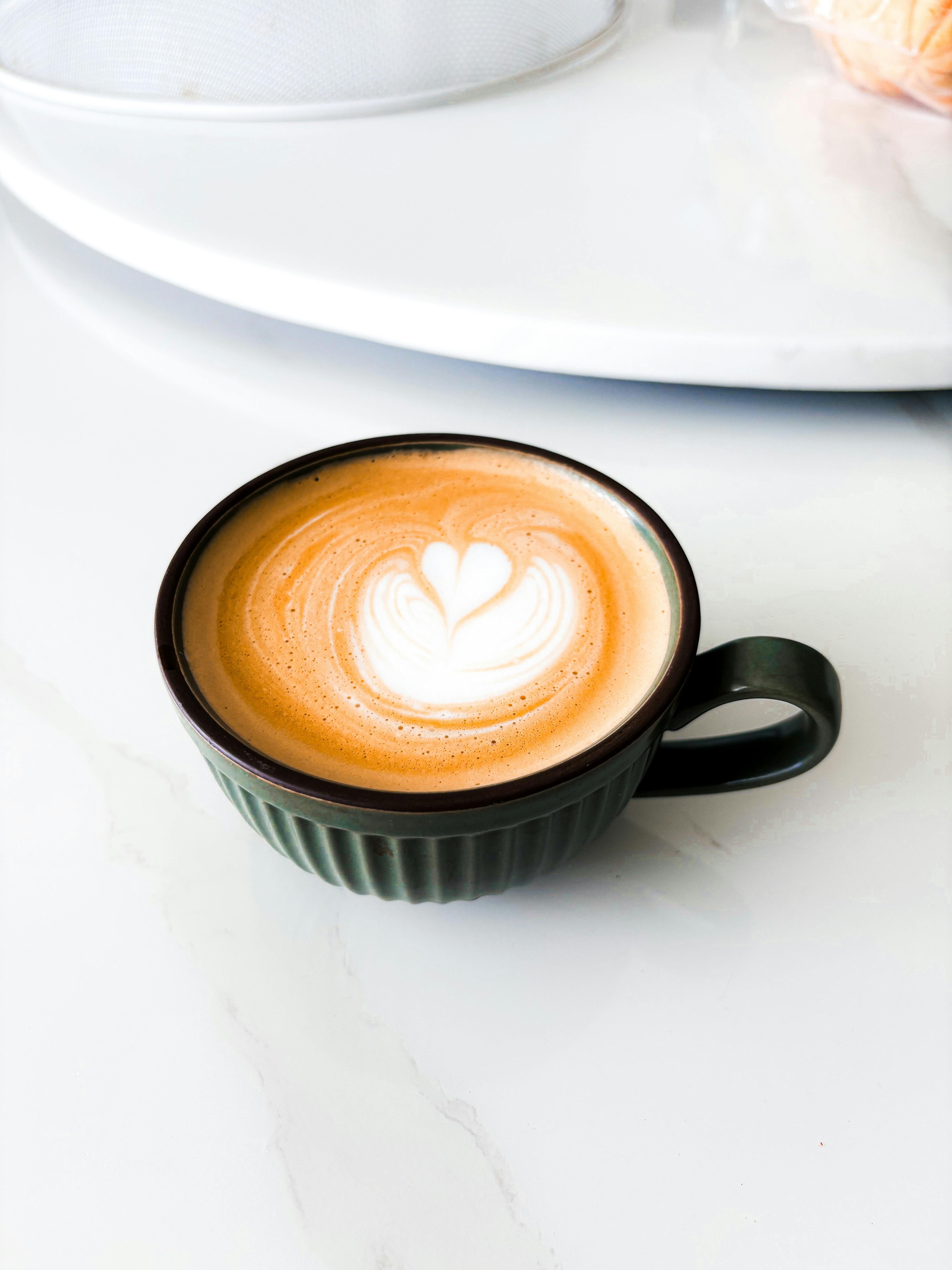 a cup of coffee with a heart drawn on it